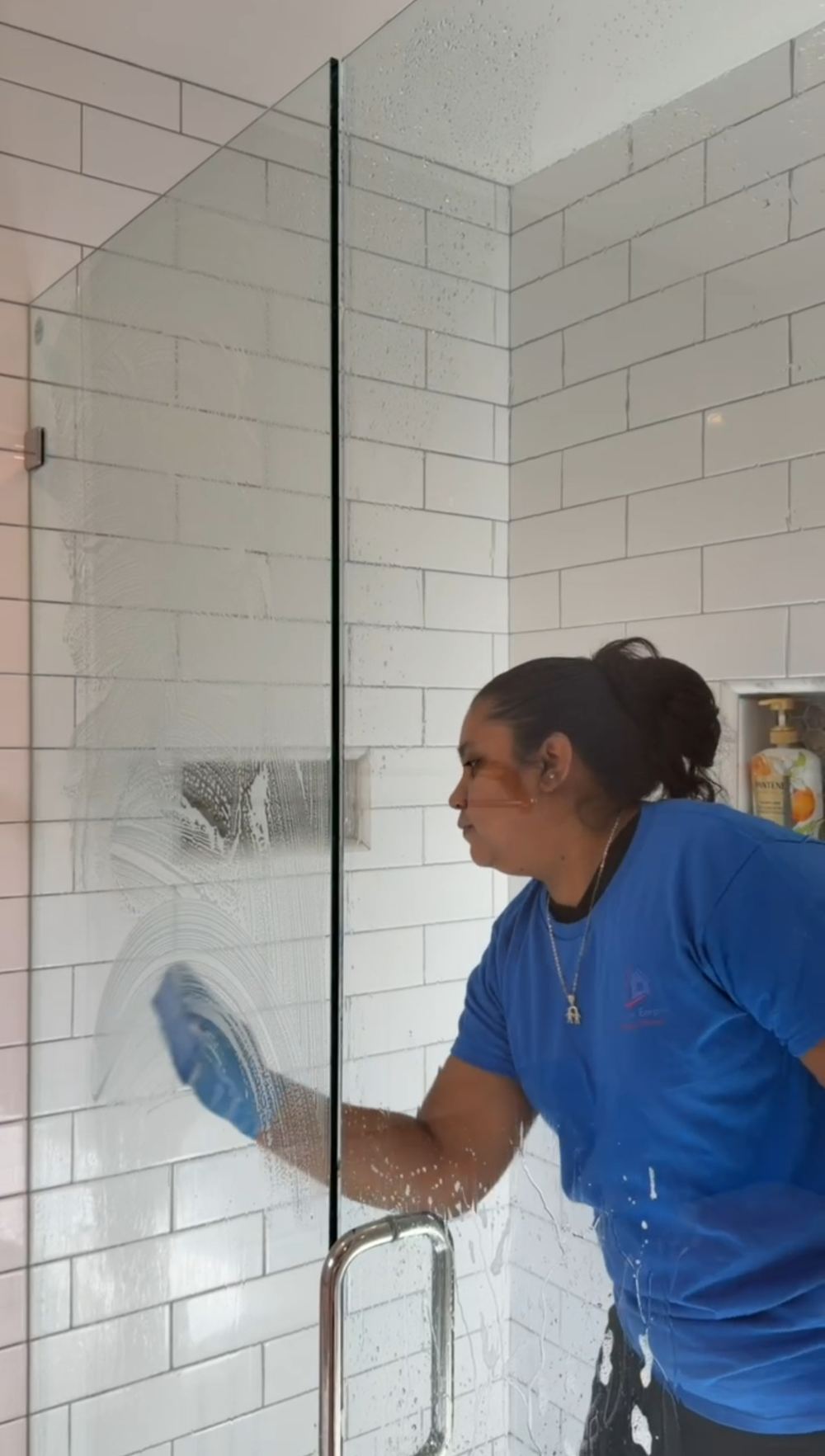 A Pristine Empire cleaner hand-detailing shower glass on a San Jose deep clean